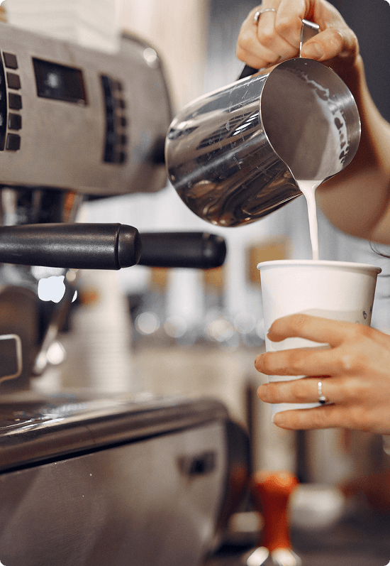 Skilled barista preparing specialty coffee at Locus Café
