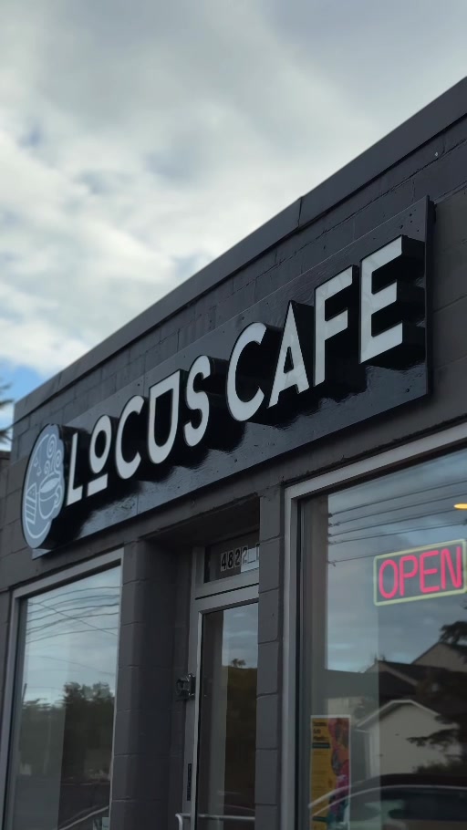 Locus Café’s sign and glass entrance on Pacific Avenue